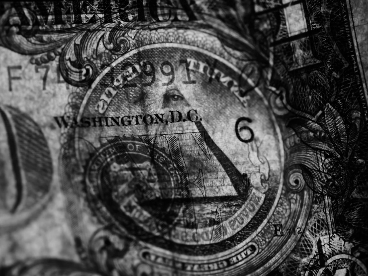services-04 Detailed close-up of a US dollar bill in grayscale highlighting symbols and textures.