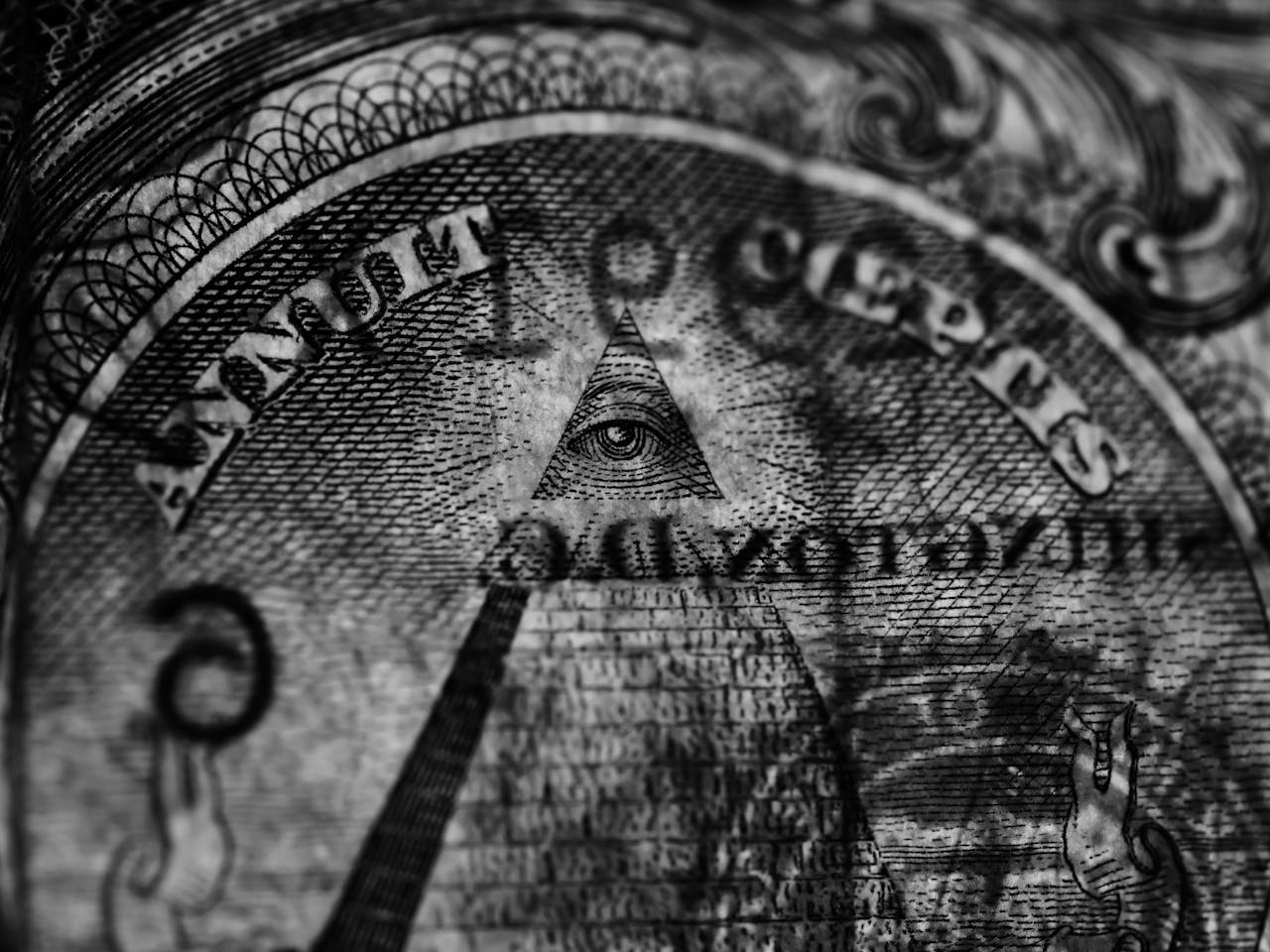 our-journey-03 Detailed grayscale image focusing on the Eye of Providence from a US dollar bill.