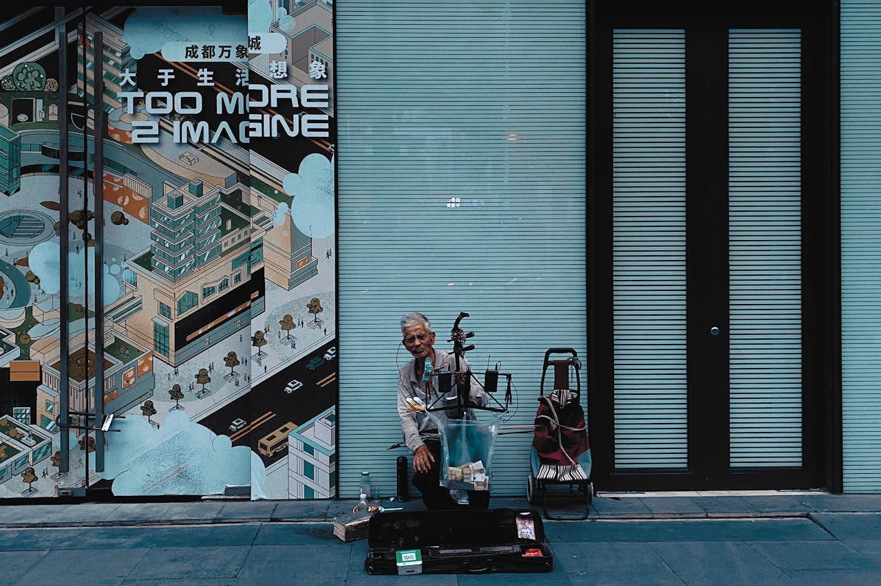Elderly musician performing on the street in Chengdu with traditional Chinese instruments.